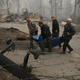 Yuba and Butte County sheriff deputies carry a body bag with a deceased victim of the Camp Fire
